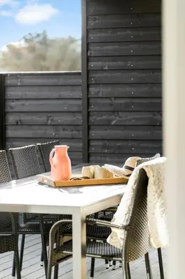 a table with a vase sitting on top of it at 362-Harboore-Gloryvej-6 in Harboør