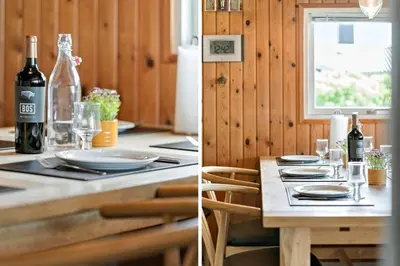 a dining room table with a bottle of wine and glasses at 111-Harboore-Vejlby-Klit-125 in Harboør