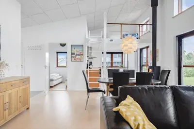 a living room with a couch and a dining room at G161-Lemvig-Porsevej-61 in Lemvig