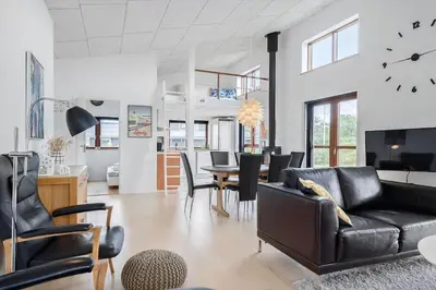 a living room with a couch and a dining room at G161-Lemvig-Porsevej-61 in Lemvig