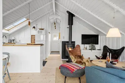 a living room with a blue couch and a table at 225-Harboore-Neerlandiavej-268 in Harboør