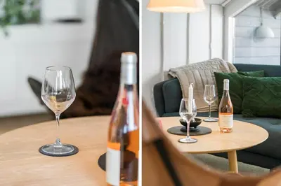 a table with two glasses and a bottle of wine at 225-Harboore-Neerlandiavej-268 in Harboør