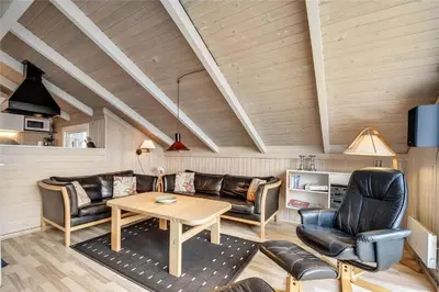 a living room with a couch and a table at 205-Harboore-Doblervej-39 in Harboør