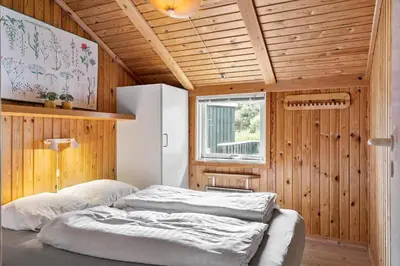 a bedroom with two beds in a wooden room at 202-Harboore-Viktoriavej-12-a in Harboør