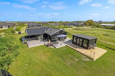 an overhead view of a black house on a field at G195-Lemvig-Porsevej-95 in Lemvig