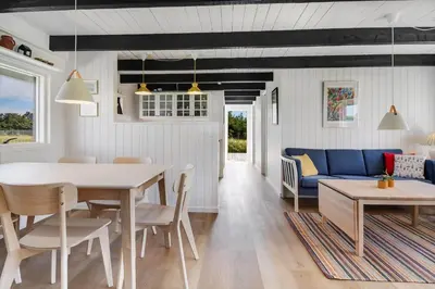 a living room with a table and a blue couch at 301-Harboore-Themisvej-11 in Harboør
