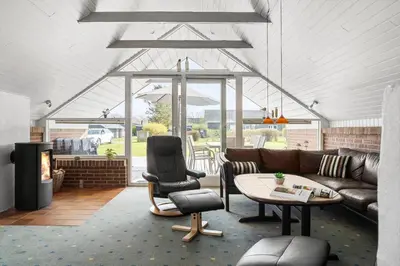 a living room with a couch and a table and chairs at G149-Lemvig-Porsevej-49 in Lemvig