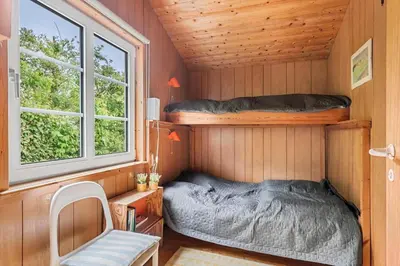 a small room with a bed and a window at G398-Lemvig-Violvej-98 in Lemvig