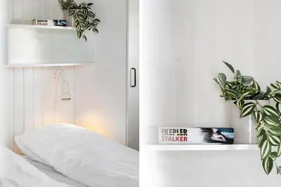 a bedroom with a white bed and a plant at 154-Harboore-Vejlby-Klit-103 in Harboør