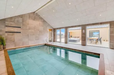 an indoor swimming pool in a home with a large room at 350-Harboore-Alkajavej-13-A in Harboør