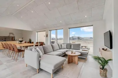 a living room with a couch and a table at 350-Harboore-Alkajavej-13-A in Harboør