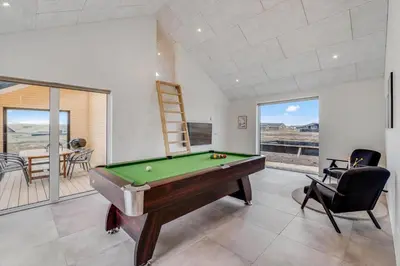 a pool table in a living room with a view at 350-Harboore-Alkajavej-13-A in Harboør