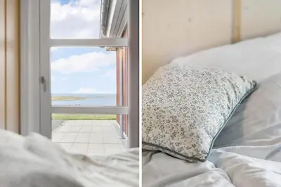 a bed with a pillow next to a window at G336-Lemvig-Myntevej-36 in Lemvig