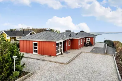 a row of red houses with the ocean in the background at G336-Lemvig-Myntevej-36 in Lemvig