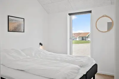 a white bed in a room with a window at 272-Harboore-Neerlandiavej-196 in Harboør