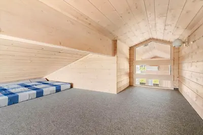 a large room with a bed and a window at 104-Harboore-Neerlandiavej-29 in Harboør