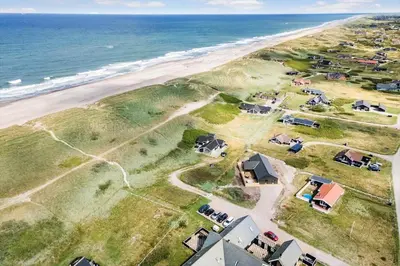 an aerial view of a beach with houses and the ocean at 104-Harboore-Neerlandiavej-29 in Harboør