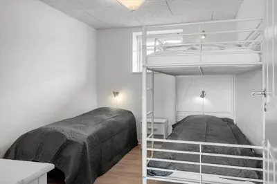 a bedroom with two bunk beds and a mirror at 181-Harboore-Vejlby-Klit-78 in Harboør