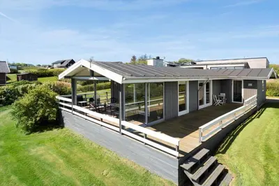 a house with a large deck on a lawn at G319-Lemvig-Violvej-19 in Lemvig