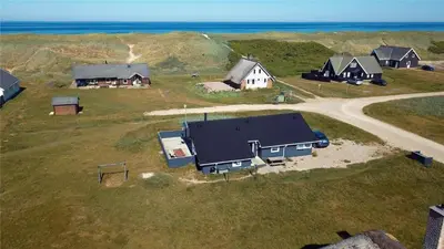 an aerial view of a group of houses and the ocean at 304-Harboore-Fourmivej-59 in Harboør