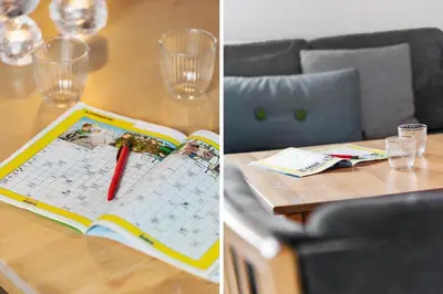a table with a book and a pen and glasses at 370-Harboore-Strandvejen-53 in Harboør