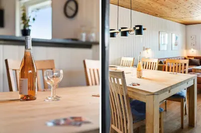 a bottle of wine sitting on a table with a wine glass at 182-Harboore-Vejlby-Klit-153-a in Harboør