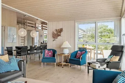 a living room with blue chairs and a table at G126-Lemvig-Bynkevej-26 in Lemvig
