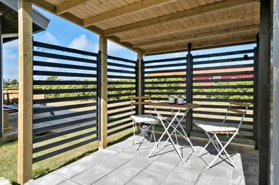 a patio with a table and two chairs on it at 204-Harboore-Vejlby-Klit-33 in Harboør