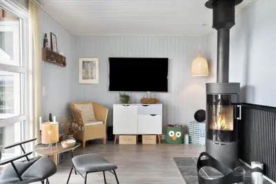 a living room with a fireplace and a tv at 281-Harboore-Vejlby-Klit-27 in Harboør