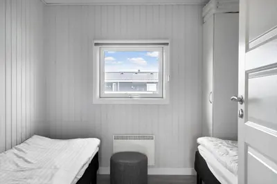 a small room with a bed and a window at 281-Harboore-Vejlby-Klit-27 in Harboør