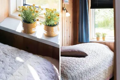a bedroom with two potted plants on a window sill at G192-Lemvig-Violvej-92 in Lemvig