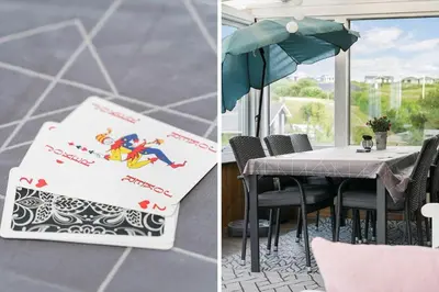a table with an umbrella and a table with chairs at G192-Lemvig-Violvej-92 in Lemvig