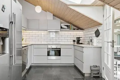a white kitchen with white cabinets and appliances at 149-Harboore-Vejlby-Klit-175 in Harboør