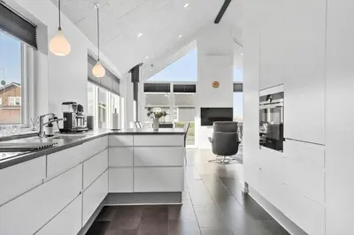 a kitchen with white cabinets and a large window at G331-Lemvig-Myntevej-31 in Lemvig