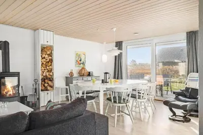 a living room with a couch and a table and chairs at G113-Lemvig-Nellikevej-13 in Lemvig