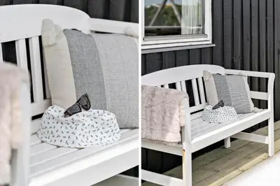 a white bench with pillows and a purse at 121-Harboore-Vejlby-Klit-173-a in Harboør