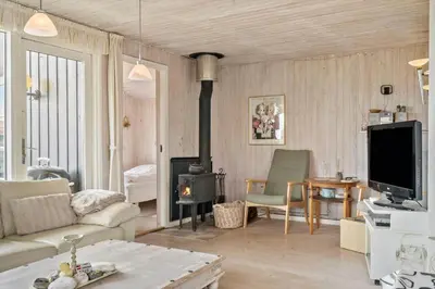 a living room with a couch and a fireplace at 121-Harboore-Vejlby-Klit-173-a in Harboør