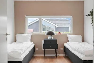 two beds in a room with a window at 237-Harboore-Neerlandiavej-17 in Harboør