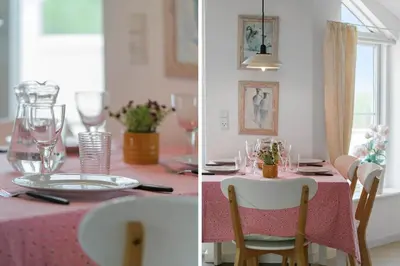 a dining room table with a pink table cloth and glasses at 325-Harboore-Skalvej-4-c in Harboør