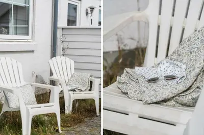 a pair of white chairs sitting on a porch at 325-Harboore-Skalvej-4-c in Harboør