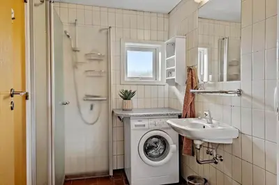 a bathroom with a washing machine and a sink at 273-Harboore-Neerlandiavej-146 in Harboør