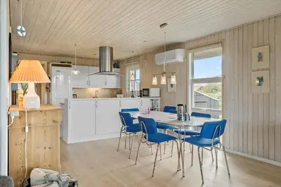 a kitchen and dining room with a table and chairs at 273-Harboore-Neerlandiavej-146 in Harboør