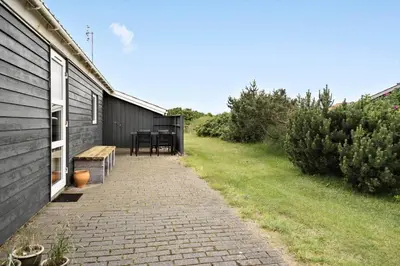a brick walkway next to a house with a table at 273-Harboore-Neerlandiavej-146 in Harboør