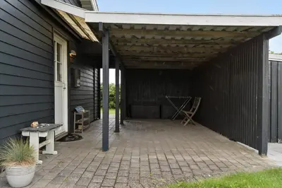 a patio with awning on the side of a house at 273-Harboore-Neerlandiavej-146 in Harboør