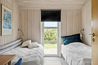 two beds in a room with a window at 273-Harboore-Neerlandiavej-146 in Harboør