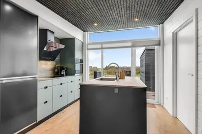 a kitchen with a sink and a large window at G408-Lemvig-Violvej-8 in Lemvig