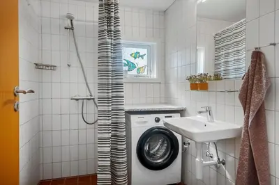a bathroom with a washing machine and a sink at 138-Harboore-Neerlandiavej-6 in Harboør