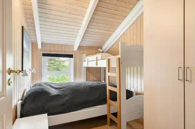 a bedroom with a bunk bed in a house at 267-Harboore-Vaermlandvej-10 in Harboør