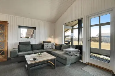 a living room with a couch and a table at 100-Harboore-Vejlby-Klit-51 in Harboør