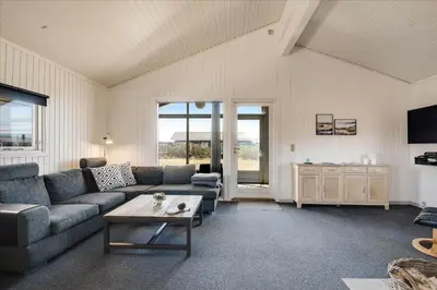 a living room with a couch and a table at 100-Harboore-Vejlby-Klit-51 in Harboør